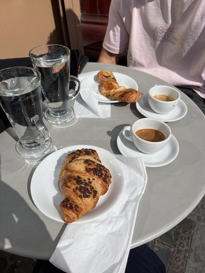 Two espressos and pastries on a cafe table
