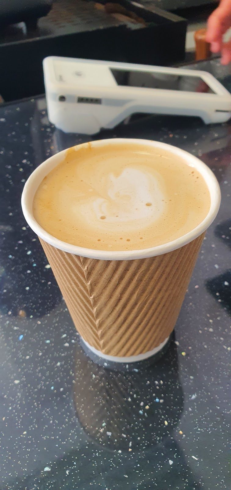 A takeaway latte with leaf art